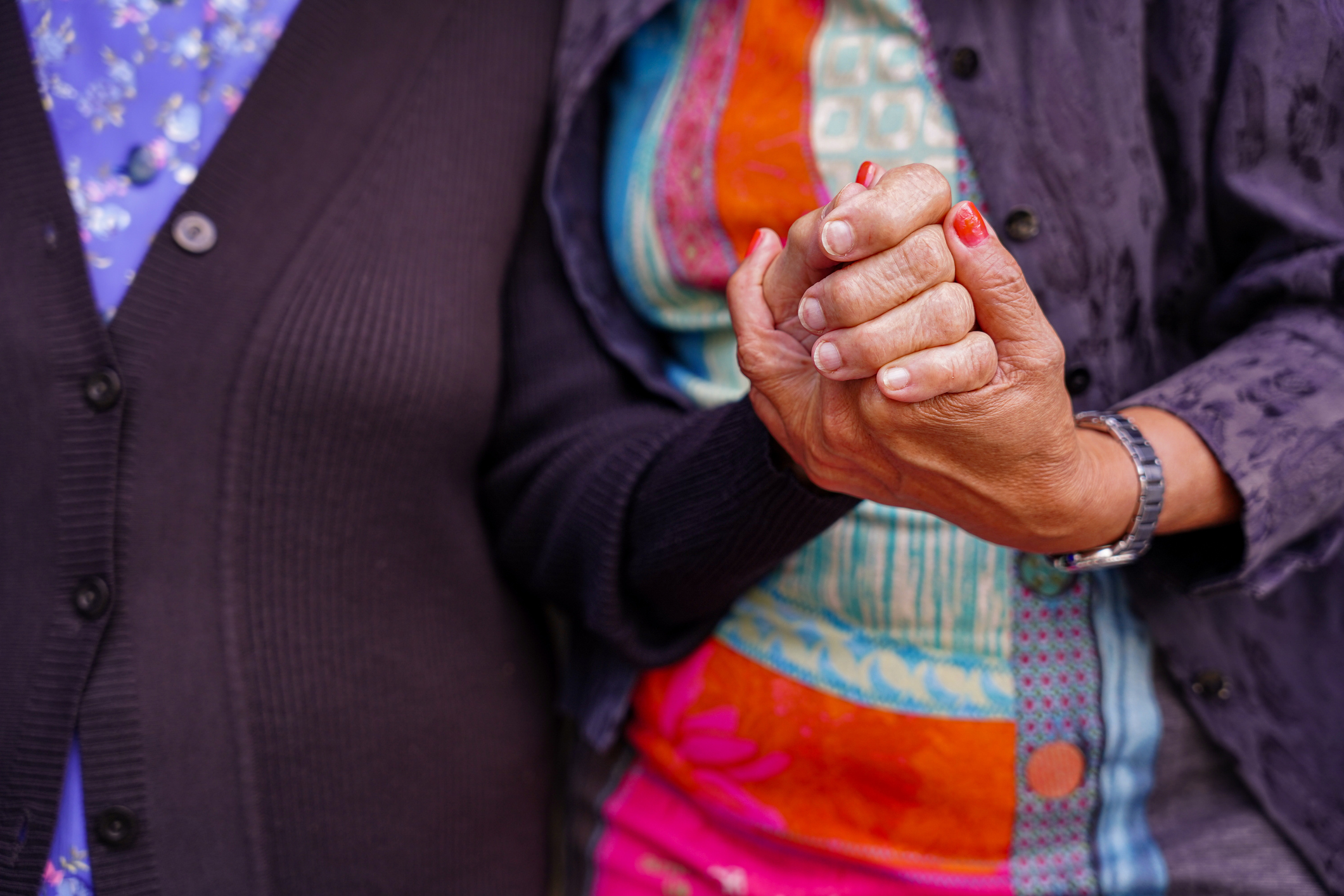 an unrecognizable caregiver giving support of an old woman. care and dependence in old age. Lady with dementia.